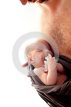 Happy father`s day! A newborn baby in dadâ€™s arms is sleeping, a pacifier for babies. Happy fatherhood concept