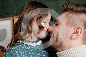 Happy Father& x27;s Day. Smiling young dad embraces with big hug his adorable little child daughter at home. Single