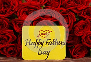 Happy Father`s day text with Red roses in a bunch as a background.