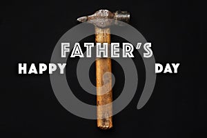 Happy father`s day text sign on working tools hammer on black ru
