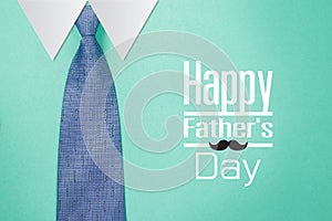 Happy Father`s Day text with tie on green paper