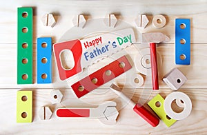 Happy Father`s day tools. Wooden toys, including a hammer, a wrench and a screwdriver.