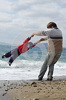 Happy father and son on the beach photo