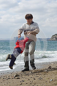 Happy father and son on the beach photo