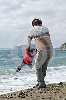 Happy father and son on the beach photo