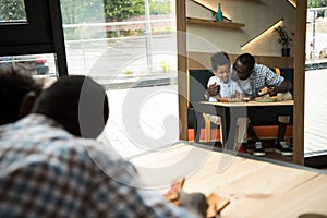 Happy father and son in cafe