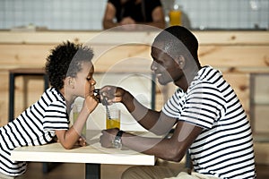 Happy father and son in cafe