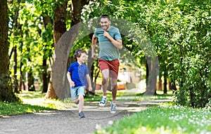 Happy father and son compete in running at park