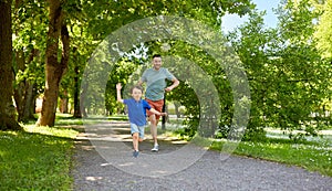 Happy father and son compete in running at park