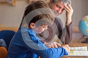Happy father and son cooperating on mathematics homework
