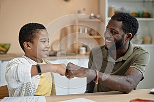 Happy Father and Son Fist Bump Doing Homework