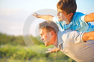 Happy father and son having fun outdoors