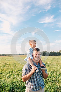 Happy Father and Son having fun over beautiful sky outdoors