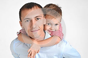 Happy father and son hugging on isolated white background.