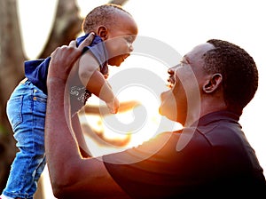 Happy father and son at the park at sunset. Father's day. photo