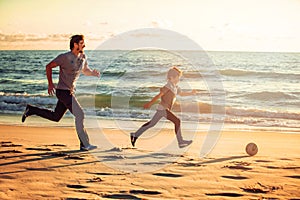 Happy father and son play soccer or football on