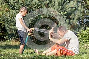 Happy father and son playing in the garden at the day time.