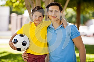Happy father and son playing soccer