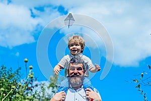 Happy father with son playing with toy plane. Dream to be pilot. Father with child have fun joy on nature at day time