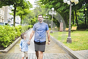 Happy father and son portrait walking together having fun