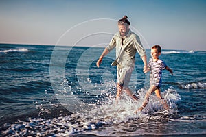 Happy father and son,running and having fun on the beach