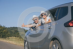 Happy father and son sitting in the car at the day time