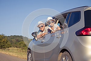 Happy father and son sitting in the car at the day time