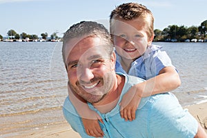 Happy father and son smiling outdoors beach