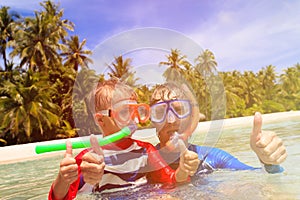 Happy father and son snorkeling on beach