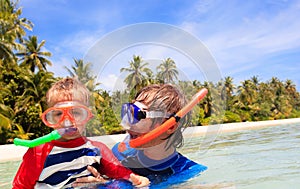 Happy father and son snorkeling on beach