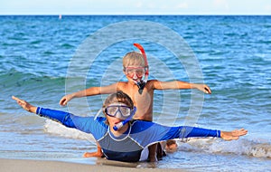 Happy father and son snorkeling on beach