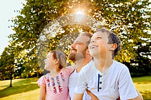 Happy father spending time with children in park