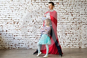 Happy father in superhero costume and his daughter