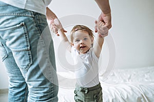 Happy father young man and baby girl little daughter having fun in children room at home