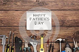 Happy Fathers Day background, card on rustic wood with repair tools