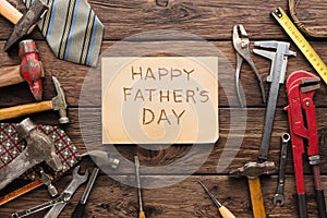 Happy Fathers Day background, card on rustic wood with repair tools