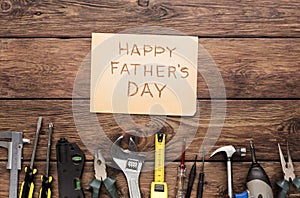 Happy Fathers Day background, card on rustic wood with repair tools