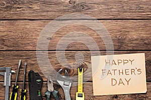 Happy Fathers Day background, card on rustic wood with repair tools