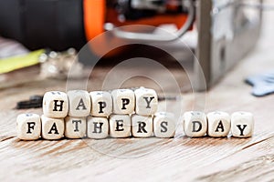 Happy Fathers Day blocks on a rustic wood background.