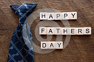 Happy fathers day with a blue tie and scrable letters