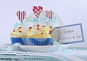 Happy Fathers Day bright and cheery red white and blue decorated cupcakes with heart toppers and gift tag photo