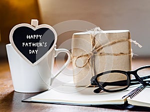 Happy fathers day concept. coffee cup with gift box, heart tag w