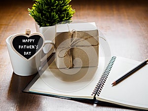 Happy fathers day concept. coffee cup with gift box, heart tag w