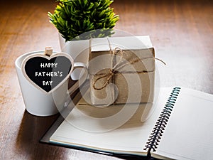 Happy fathers day concept. coffee cup with gift box, heart tag w