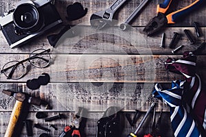 Happy fathers day concept. Top view of border of tools and ties, retro film camera on dark wooden table background. Flat lay