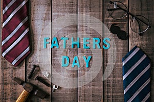 Happy fathers day concept. Top view of mamy tools and ties, retro glasses on dark wooden table background. Flat lay