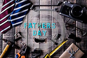 Happy fathers day concept. Top view of mamy tools and ties, retro glasses on dark wooden table background. Flat lay