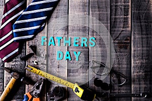 Happy fathers day concept. Top view of mamy tools and ties, retro glasses on dark wooden table background. Flat lay