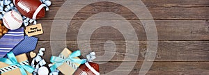 Happy Fathers Day gift tag with corner border of gifts, ties, games and sport items on a rustic wood banner background