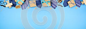 Happy Fathers Day gift tag with long border of ties, gifts and games on a blue banner background